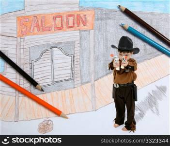 Four year old boy dressed as sheriff guarding imaginary old west town.