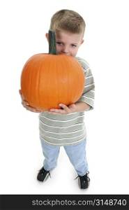 Four year old boy holding pumpkin.