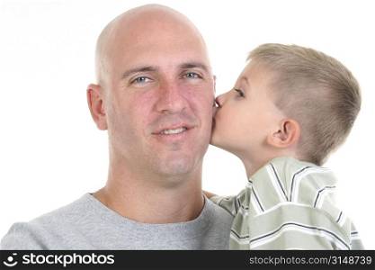Four year old boy kissing his dad on the cheek. Close-up, head