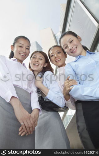 Four young businesswomen looking at the camera