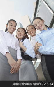 Four young businesswomen looking at the camera