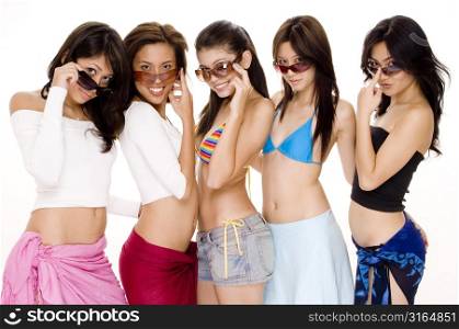 Four young women and a teenage girl wearing sunglasses and smiling