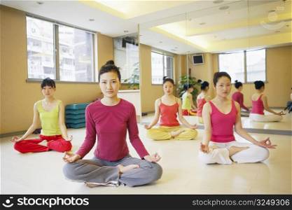 Four young women sitting in the lotus position