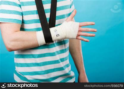 Fractures and dislocations concept. Part body male with hand in bandage. Helpful medication for painful palm arm of young man.. Part body man with bandaged hand.