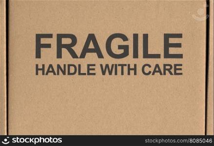 Fragile handle with care label tag. Fragile handle with care warning sign label tag on a cardboard box