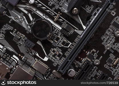 Fragment microcircuit of the motherboard or mainboard with slot and battery as background . Printed circuit board is the basis for building a computer.