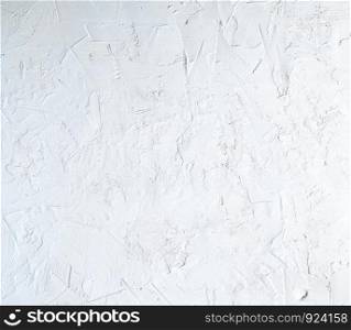 fragment of a cement background from white paint with cracks, stains of paint, vintage background