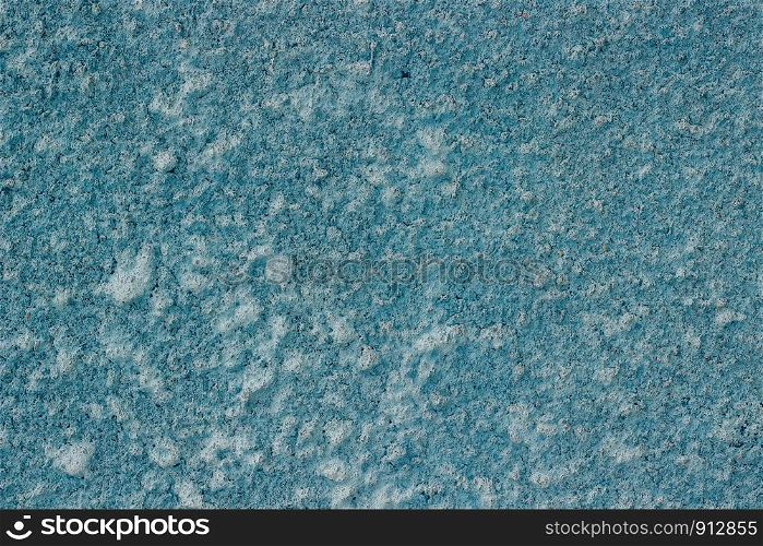 Fragment of a concrete wall painted with blue paint as a background or texture. Seamless texture.