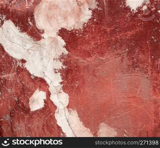 fragment of a red cracked cement wall, full frame