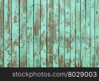 Fragment of aged wooden boards background with peeling green paint