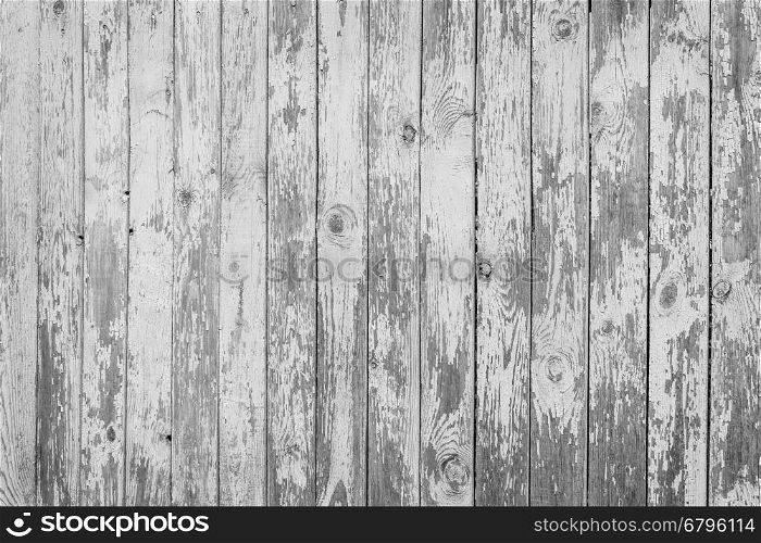 Fragment of aged wooden boards background with peeling white paint