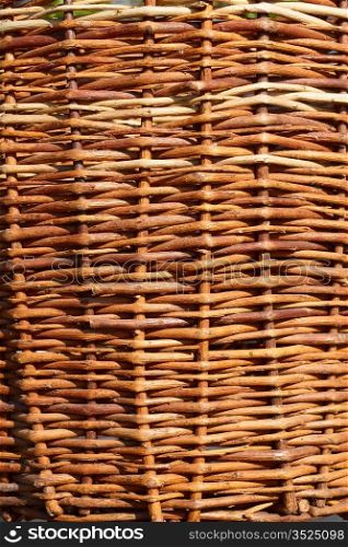 Fragment of an old wicker basket with willow twigs