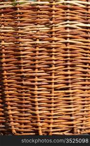 Fragment of an old wicker basket with willow twigs