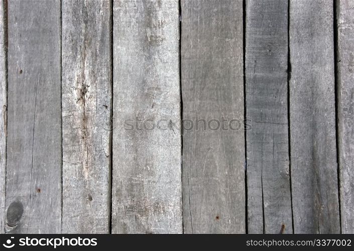 Fragment of an old wooden wall from boards with rusty nails