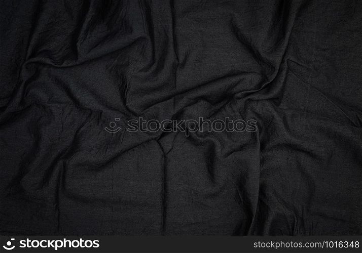 fragment of black cotton fabric with waves, full frame , close up