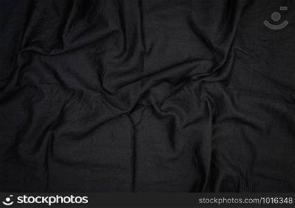 fragment of black cotton fabric with waves, full frame , close up