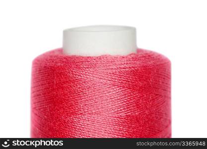 Fragment of coil with red threads isolated on white background