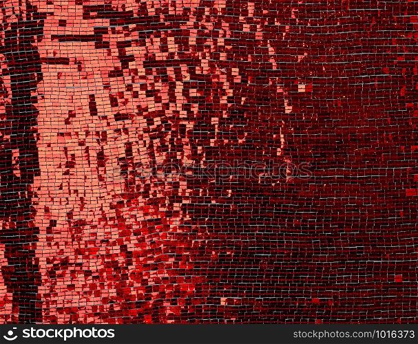 fragment of fabric embroidered with red square sequins, full frame, close up