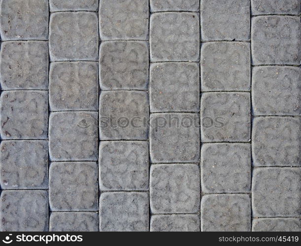 Fragment of gray concrete tiled pavement background