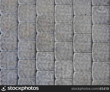 Fragment of gray concrete tiled pavement background
