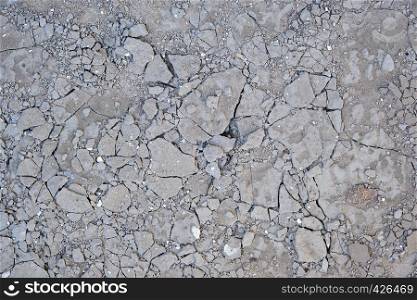 fragment of gray cracked cement floor, full frame
