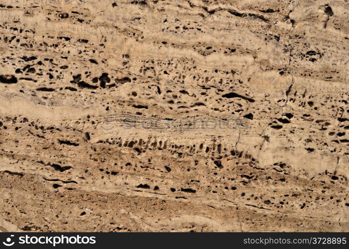 Fragment of light brown stone wall background