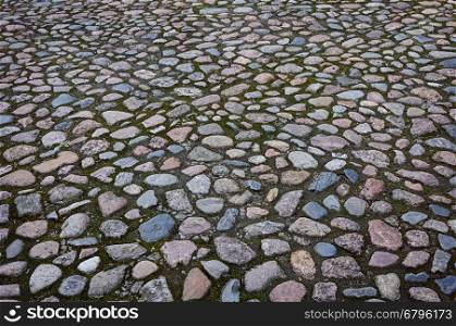 Fragment of old cobblestone pavement surface