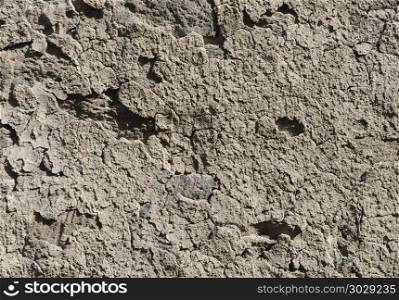 Fragment of old cracked earthen wall background. Earthen wall of old house