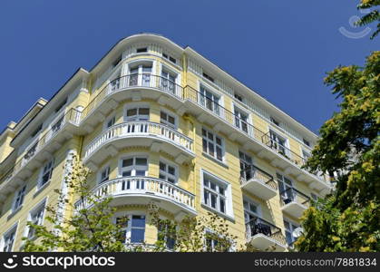 Fragment of old renovated building with balcony and ornaments