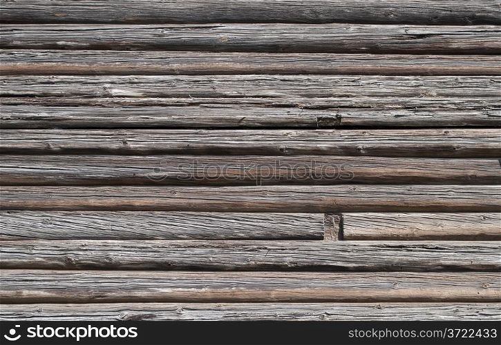 Fragment of old weathered log wall, useful as background