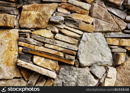 Fragment of stone wall with rough stones