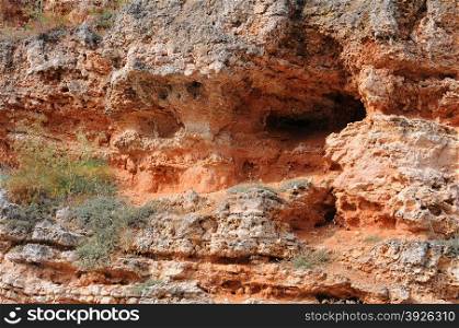 Fragment of the red caved rock near Bolata beach in Dobrudja, Bulgaria
