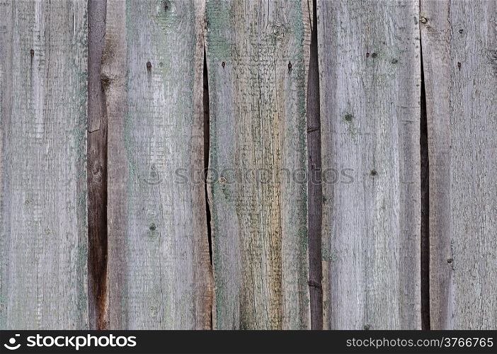 Fragment of weathered unpainted wooden fence
