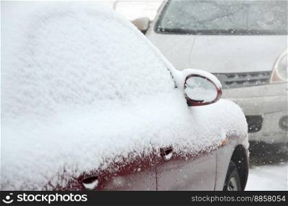 Fragments of parked cars covered with snow
