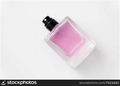 fragrance and aroma concept - bottle of perfume or pink toilette water on white background. bottle of perfume or pink toilette water