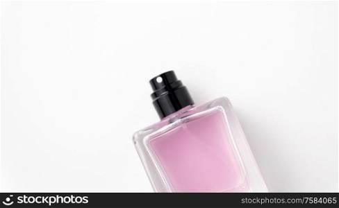 fragrance and aroma concept - bottle of perfume or pink toilette water on white background. bottle of perfume or pink toilette water