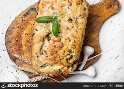 Fragrant baked bread. fresh loaf of rustic bread with garlic and herbs