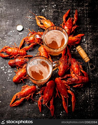 Fragrant boiled crayfish on the table. On a wooden background. High quality photo. Fragrant boiled crayfish on the table.