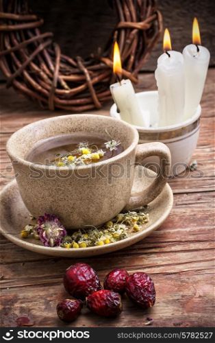 fragrant chamomile tea and briar in rustic style. healing with chamomile broth