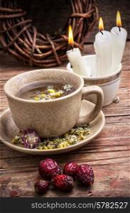 fragrant chamomile tea and briar in rustic style. healing with chamomile broth