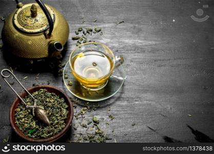 fragrant green tea with leaves. On the black chalkboard. fragrant green tea with leaves.