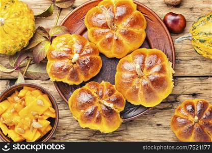 Fragrant homemade buns made from pumpkin dough.Autumn food. Homemade sweet pumpkin buns