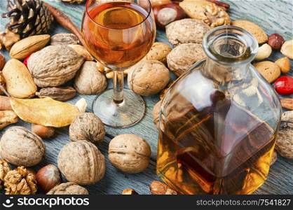 Fragrant nutty liquor tincture.Walnut liquor, sweet table alcoholic drink. Autumn nutty liquor