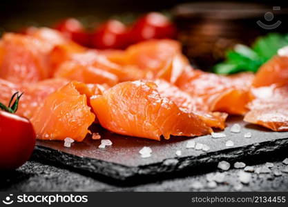 Fragrant salted salmon on a stone board. Macro background. High quality photo. Fragrant salted salmon on a stone board.