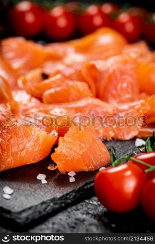 Fragrant salted salmon on a stone board. Macro background. High quality photo. Fragrant salted salmon on a stone board.