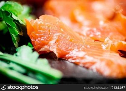 Fragrant salted salmon on a stone board. Macro background. High quality photo. Fragrant salted salmon on a stone board.