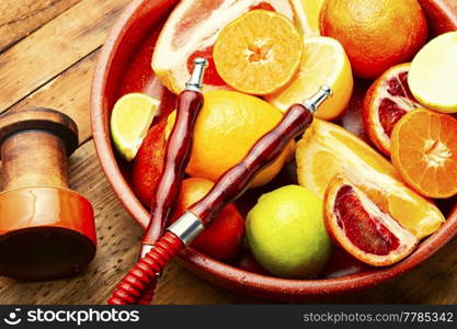 Fragrant smoking hookah or shisha with tobacco from citrus fruits.. Hookah or kalian with citrus tobacco.