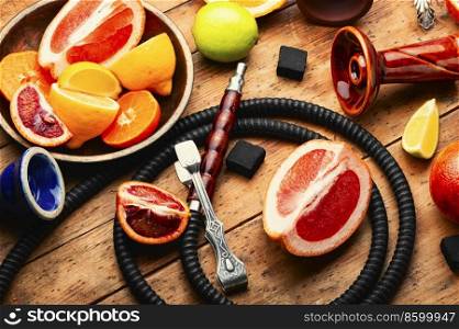 Fragrant smoking hookah or shisha with tobacco from citrus fruits. Making hookah. Eastern with citrus tobacco, smoking