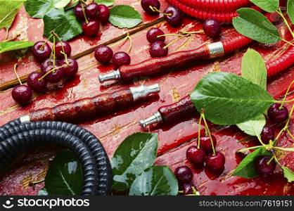 Fragrant smoking hookah with cherry tobacco.Asian tobacco hookah.. Hookah with cherry shisha tobacco.