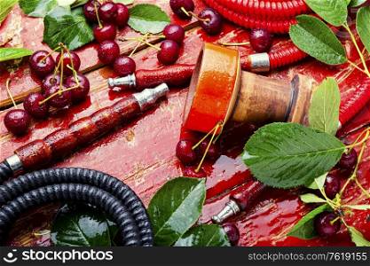 Fragrant smoking hookah with cherry tobacco.Asian tobacco hookah.. Hookah with cherry shisha tobacco.